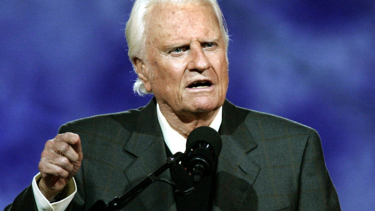 (FILES)Evangelist Billy Graham delivers his message at the Billy Graham Crusade at Flushing Meadows Park in this June 24, 2005 file photo in Flushing Meadows, New York. US Reverend Billy Graham was hospitalized November 30, 2011 for possible pneumonia, the facility treating the 93-year-old internationally renowned evangelist said. "He was admitted this afternoon," a spokeswoman for Mission Hospital in Asheville, North Carolina told AFP. The hospital said in a statement that he was admitted "for evaluation and treatment of his lungs," and that he was in stable condition and was "alert, smiling and waving at hospital staff." AFP PHOTO  Timothy A. CLARY (Photo credit should read TIMOTHY A. CLARY/AFP/Getty Images)